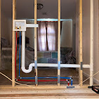 PVC and PEX rough-in plumbing in framed wall